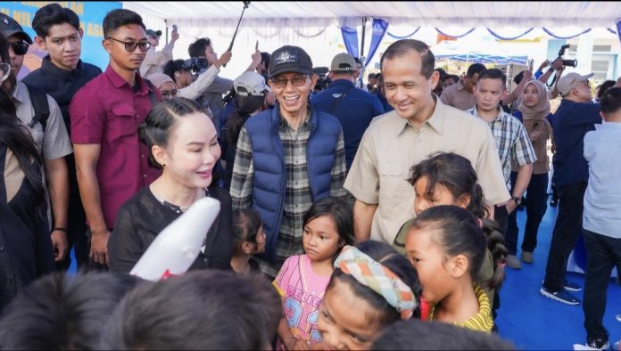 Kepala BP Batam, Amsakar Achmad dan Wakil Kepala BP Batam, Li Claudia Chandra hadiri penyerahan bantuan perbekalan dan santunan nilai rumah asal kepada masyarakat transmigrasi lokal, di Tanjung Banun, Minggu (21/12/2025). (Humas BP Batam)