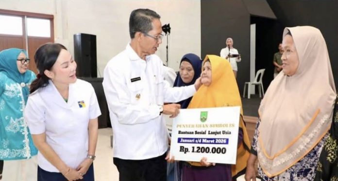 Wali Kota Batam, Amsakar Achmad, bersama Wakil Wali Kota Li Claudia Chandra menyerahkan bantuan kepada lansia secara simbolis. (Diskominfo Kota Batam)